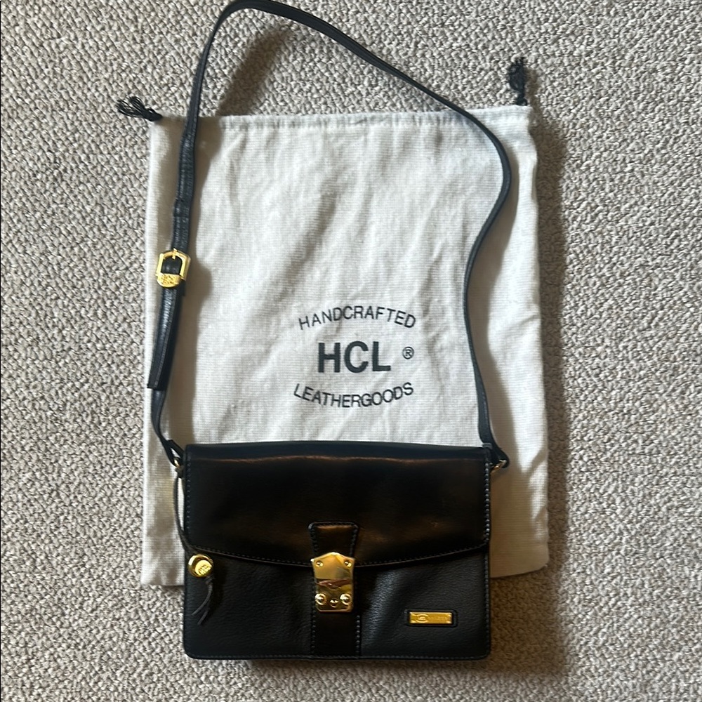 Chic Black and Gold Crossbody Bag with Structured Elegance